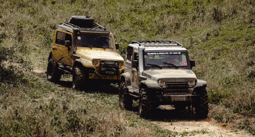 Overlanding vehicles on a rugged trail demonstrating the need for vehicle blast mitigation with polyurea coatings
